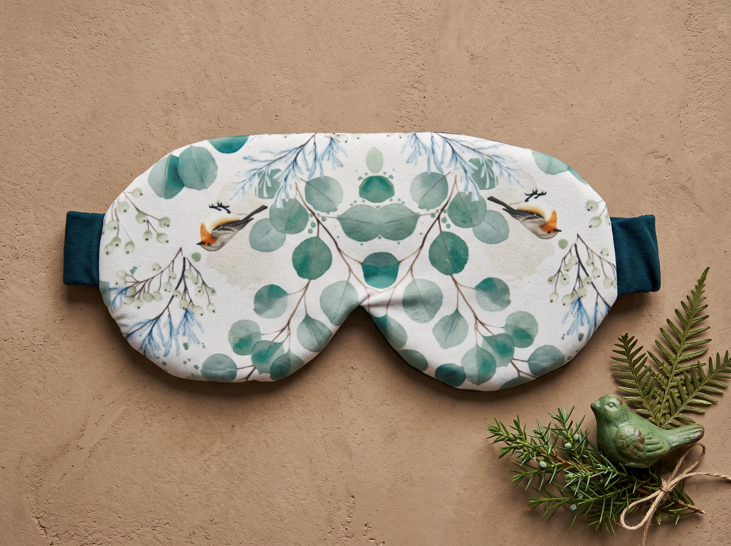 Holiday-print sleep mask with pine greenery