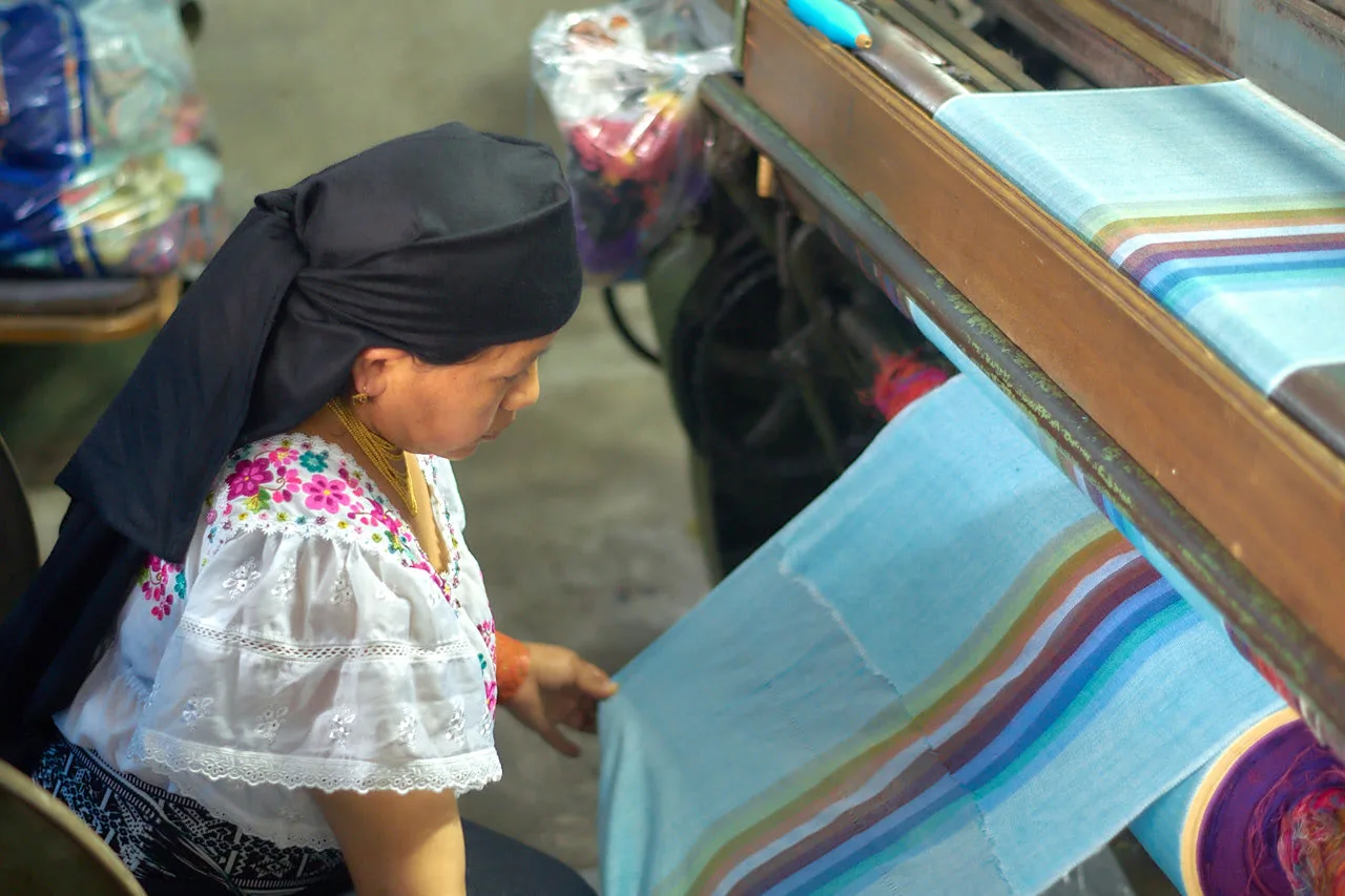 Artisan checking the quality of a woven piece