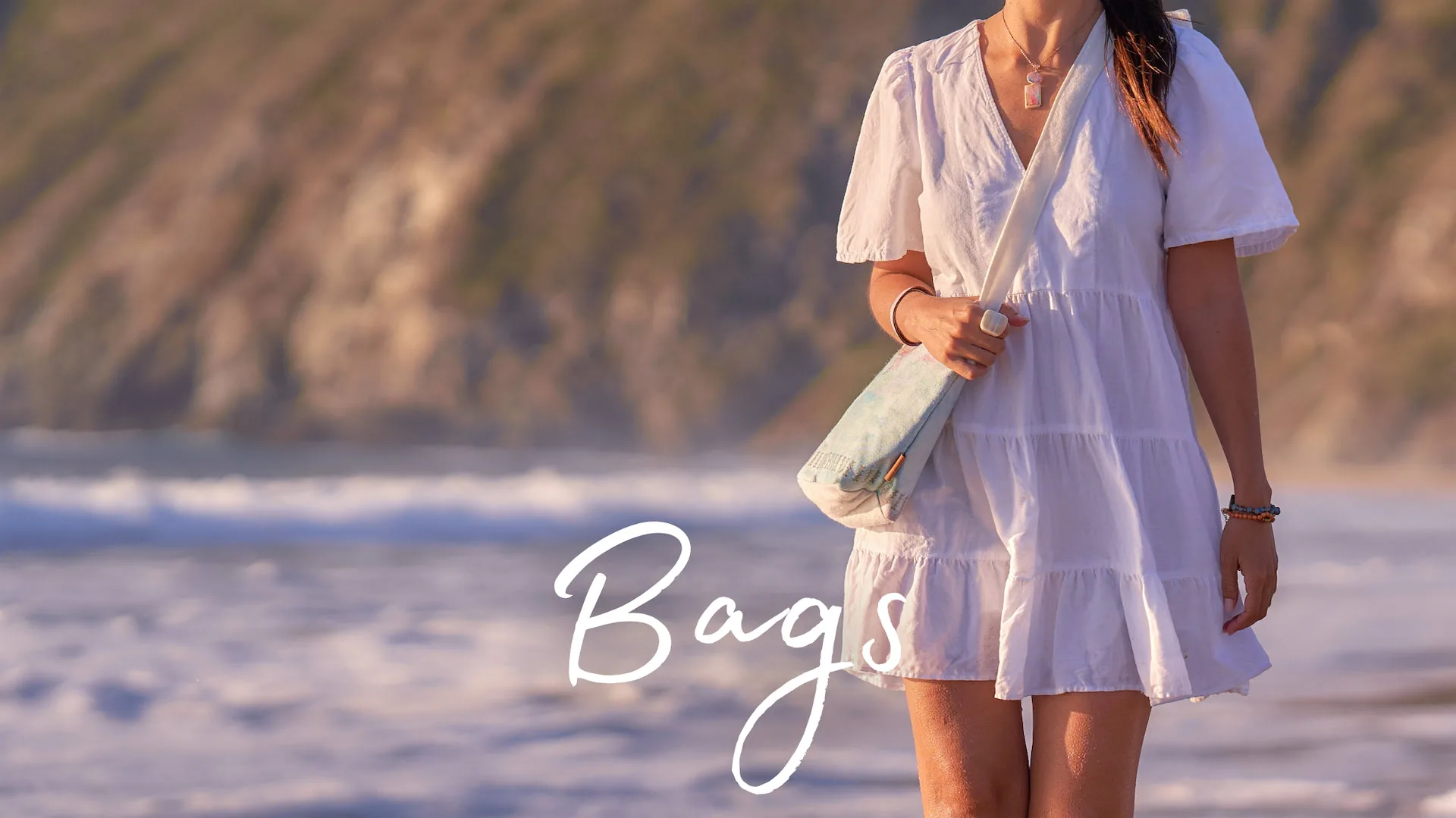 Woman carrying a woven vegan tote on the beach